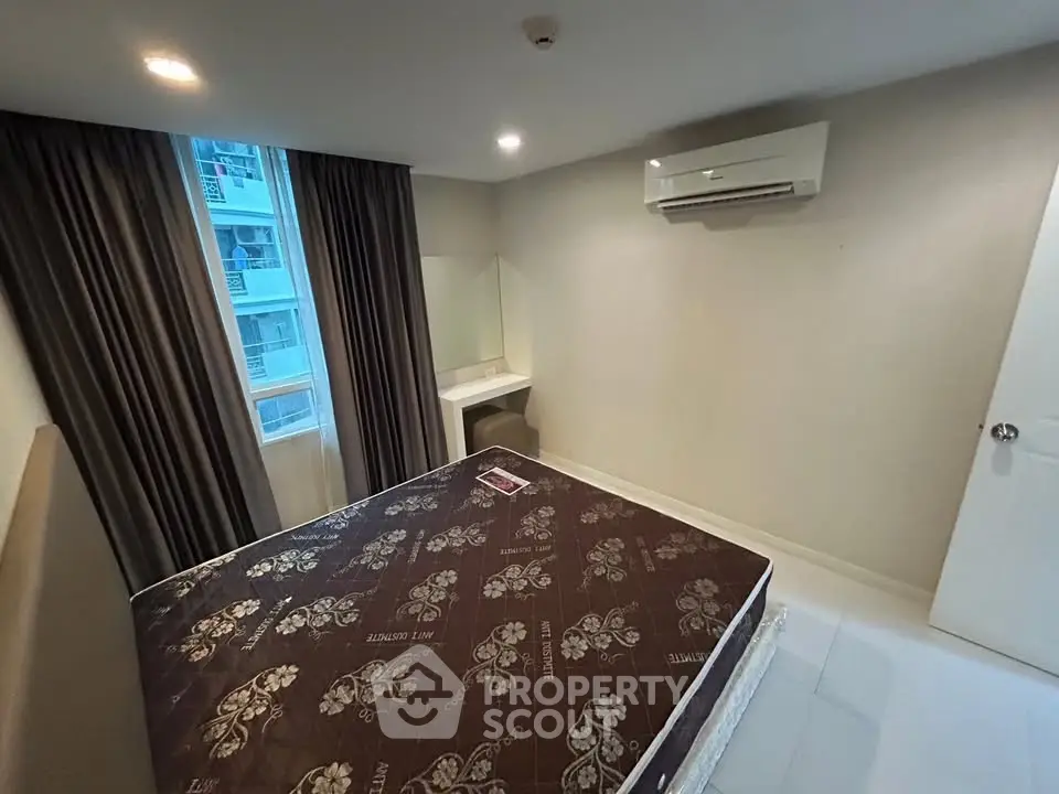 Modern bedroom with air conditioning and large window in a stylish apartment.