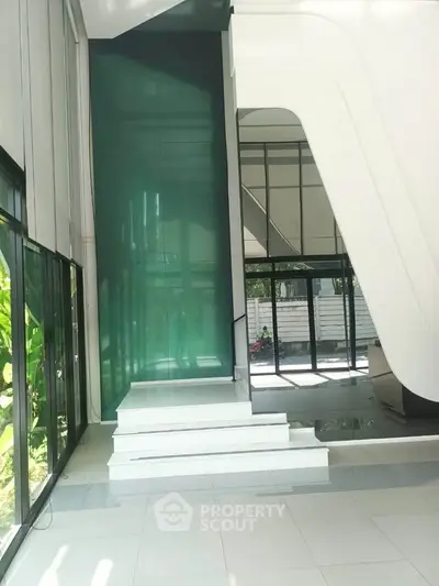 Modern building entrance with sleek design and large glass windows