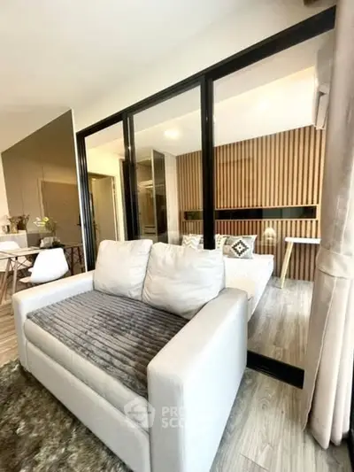 Modern living room with cozy sofa and stylish decor in open layout apartment.