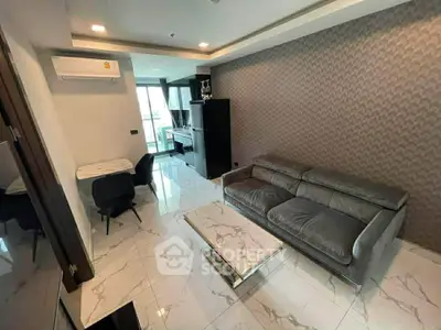Modern living room with sleek furniture and marble flooring in a stylish apartment.