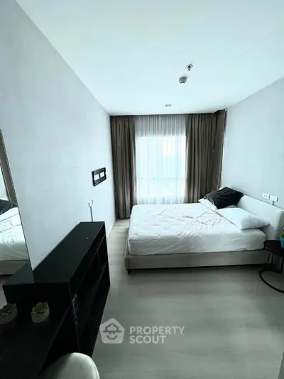 Modern minimalist bedroom with large window and neutral decor