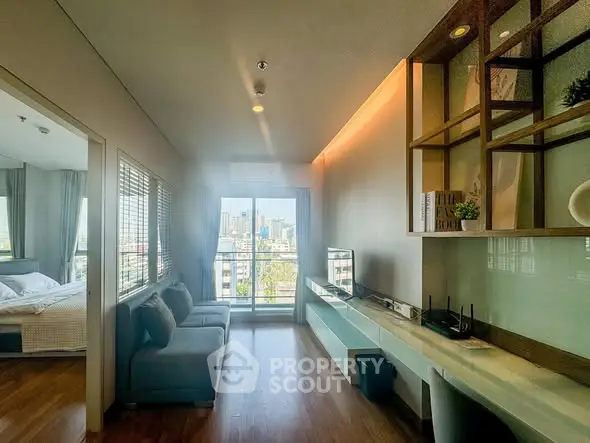 Modern living room with city view, sleek furniture, and open layout in a high-rise apartment.