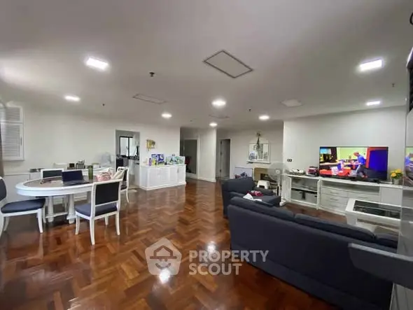 Spacious living room with elegant wooden flooring and modern furniture