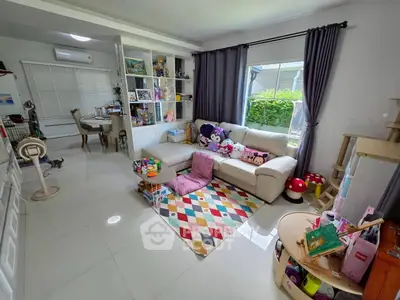 Charming living room with playful decor and garden view, perfect for family relaxation.