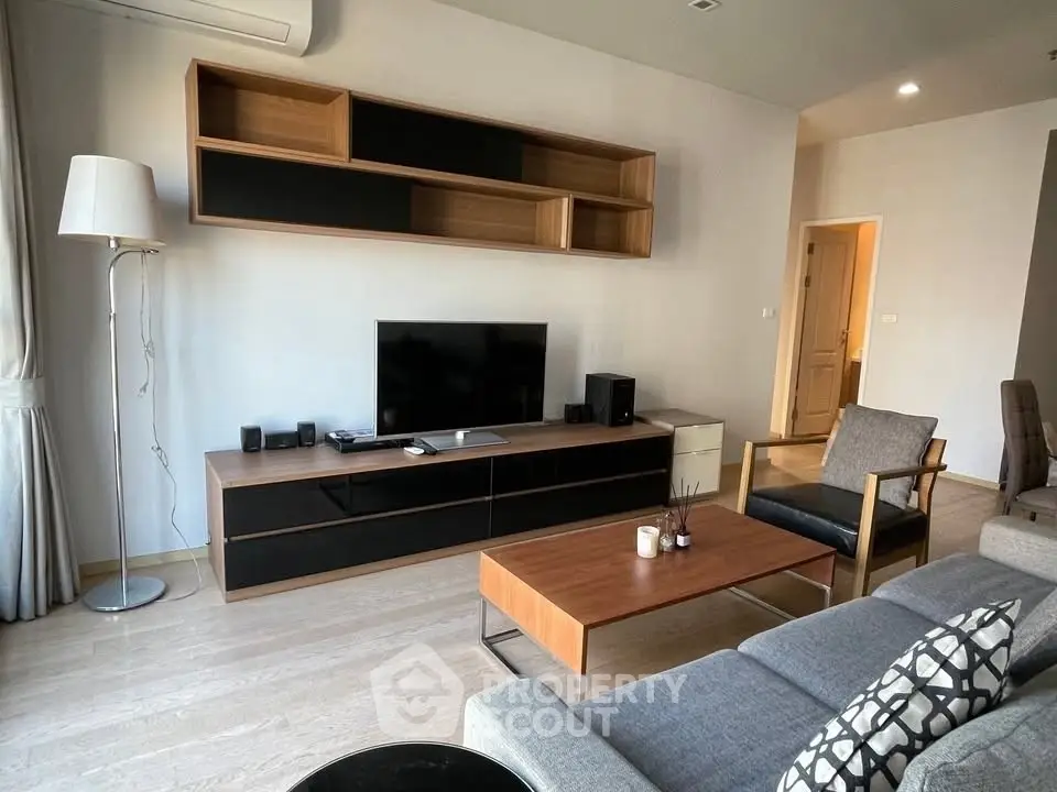 Modern living room with sleek furniture and wall-mounted shelves