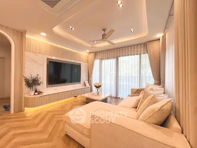 Luxurious modern living room with elegant decor and large windows.