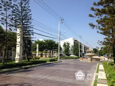 Modern residential street with lush greenery and contemporary architecture