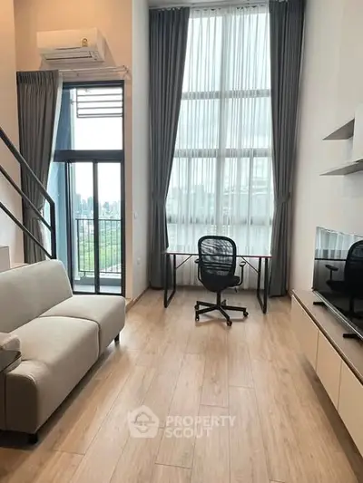 Modern living room with high ceilings, large windows, and a balcony view in a stylish apartment.