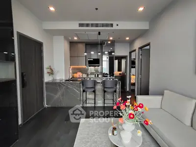 Modern open-plan living room with sleek kitchen and stylish decor