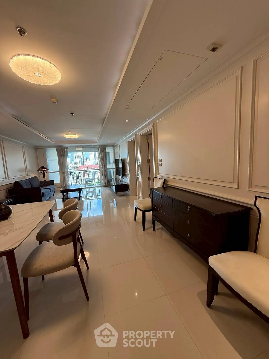 Luxurious living room with elegant furniture and city view balcony