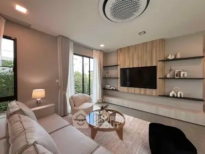 Modern living room with stylish furniture and large TV, perfect for relaxation.