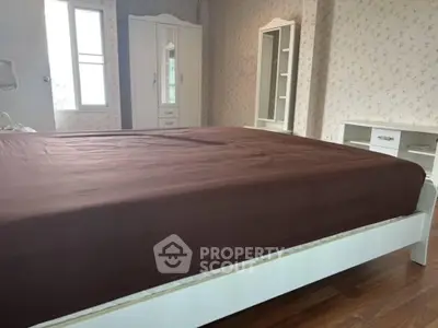 Spacious bedroom with elegant furniture and natural light