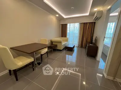 Modern living room with sleek furniture and glossy tiled flooring in a stylish apartment.