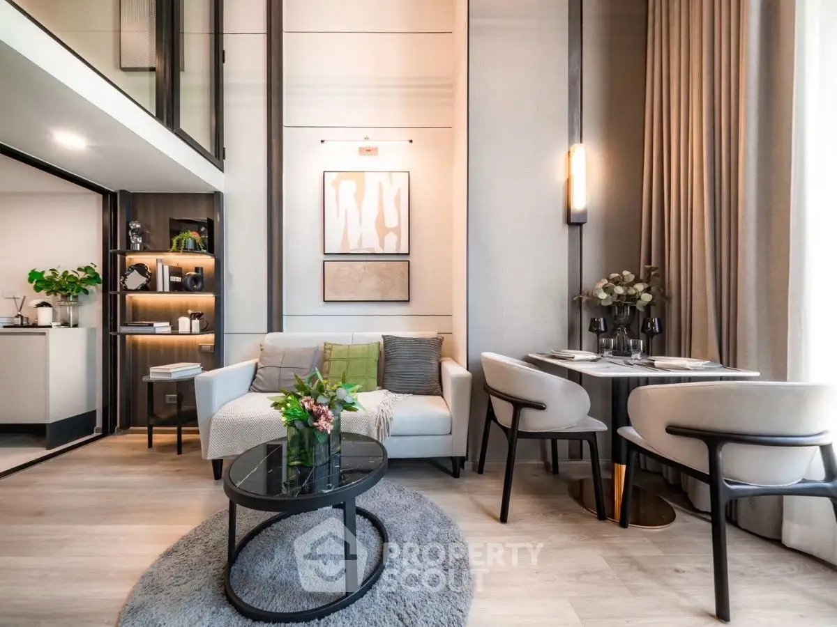 Modern living room with elegant decor, cozy seating, and stylish dining area in open-plan apartment.