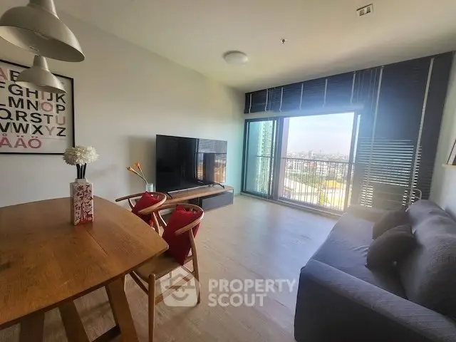 Modern living room with city view, stylish furniture, and natural light.