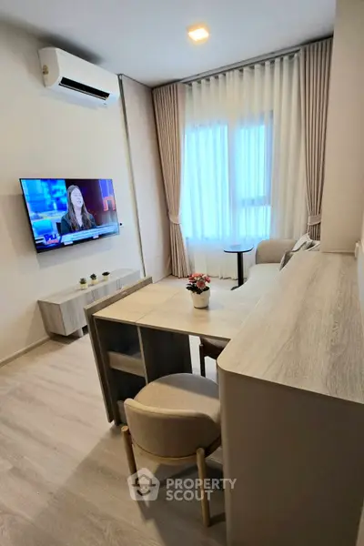 Modern living room with stylish furniture and wall-mounted TV, perfect for cozy evenings.
