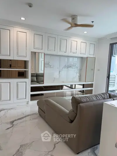 Modern living room with sleek marble flooring and elegant built-in cabinetry