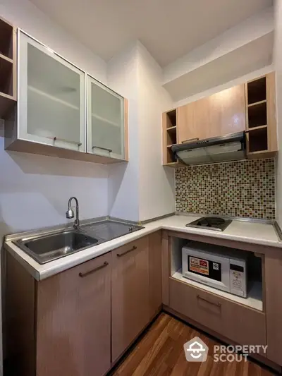 Compact modern kitchen with stylish backsplash and wooden cabinets