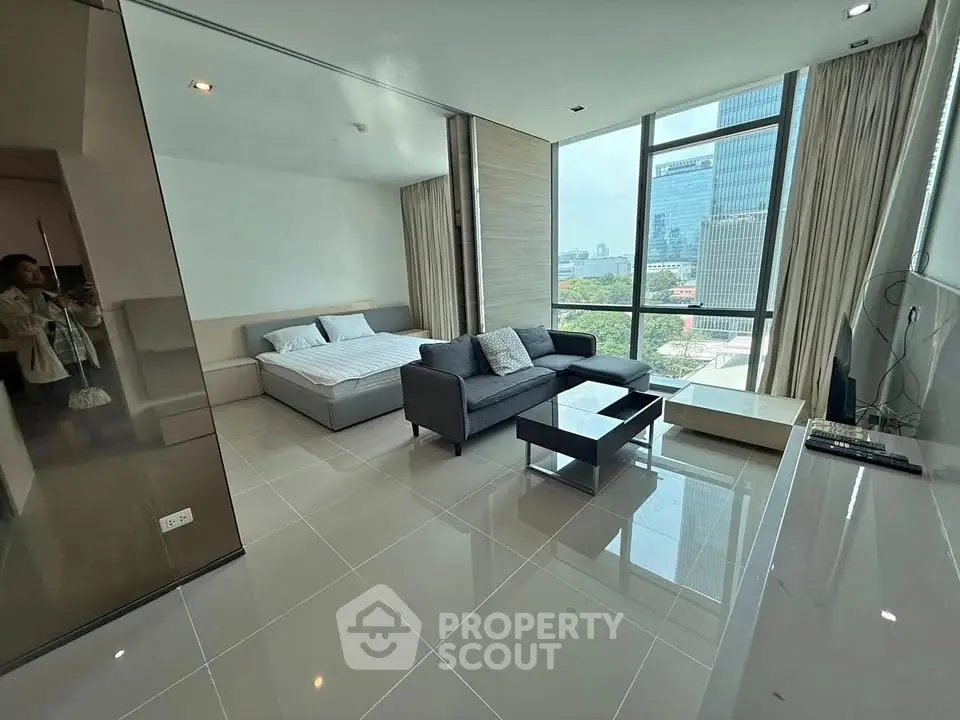Modern studio apartment with large windows and city view