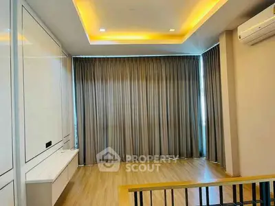 Spacious modern living room with elegant lighting and large windows
