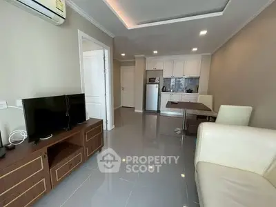 Modern living room with sleek furniture and open kitchen layout