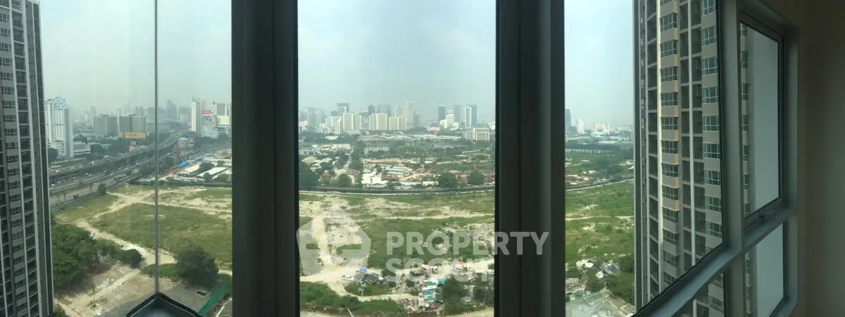 Stunning panoramic city view from high-rise apartment window, showcasing urban skyline and green spaces.
