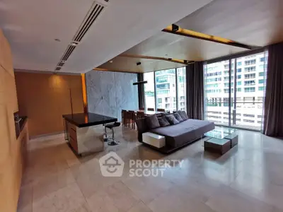 Spacious modern living room with floor-to-ceiling windows and elegant furnishings in a luxury apartment.
