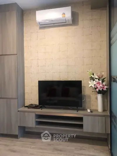 Modern living room with sleek TV unit and air conditioning