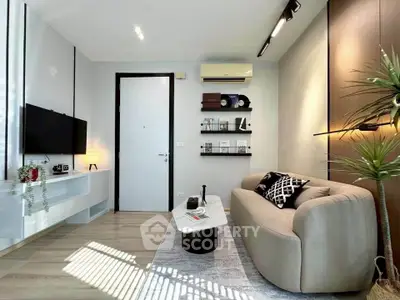 Modern living room with stylish decor and natural light, featuring a cozy sofa and sleek shelving.