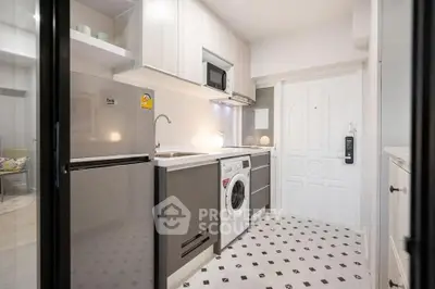 Modern compact kitchen with washing machine and stainless steel appliances