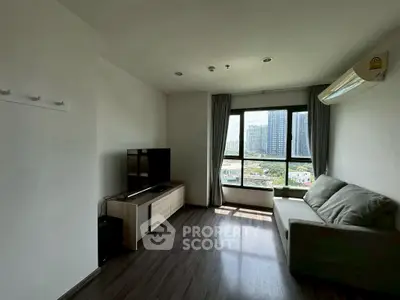 Modern living room with city view, featuring sleek furniture and natural light.