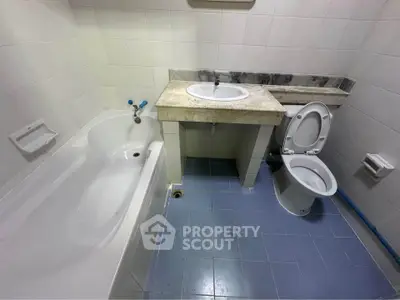 Spacious bathroom with bathtub and modern fixtures in a stylish real estate property.