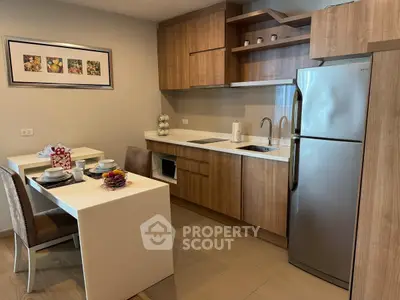 Modern kitchen with sleek wooden cabinets and stainless steel appliances