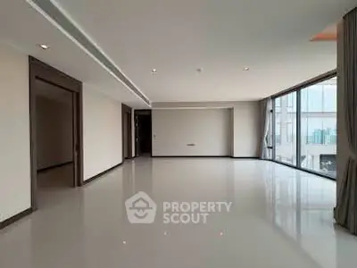 Spacious modern living room with large windows and city view