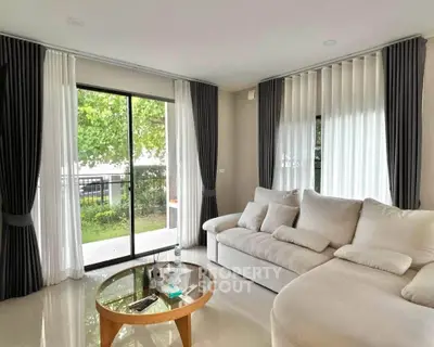 Spacious living room with elegant curtains and garden view, perfect for relaxation and entertaining.