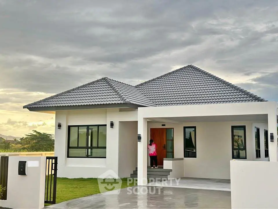 Modern single-story home with sleek design and spacious driveway, perfect for family living.