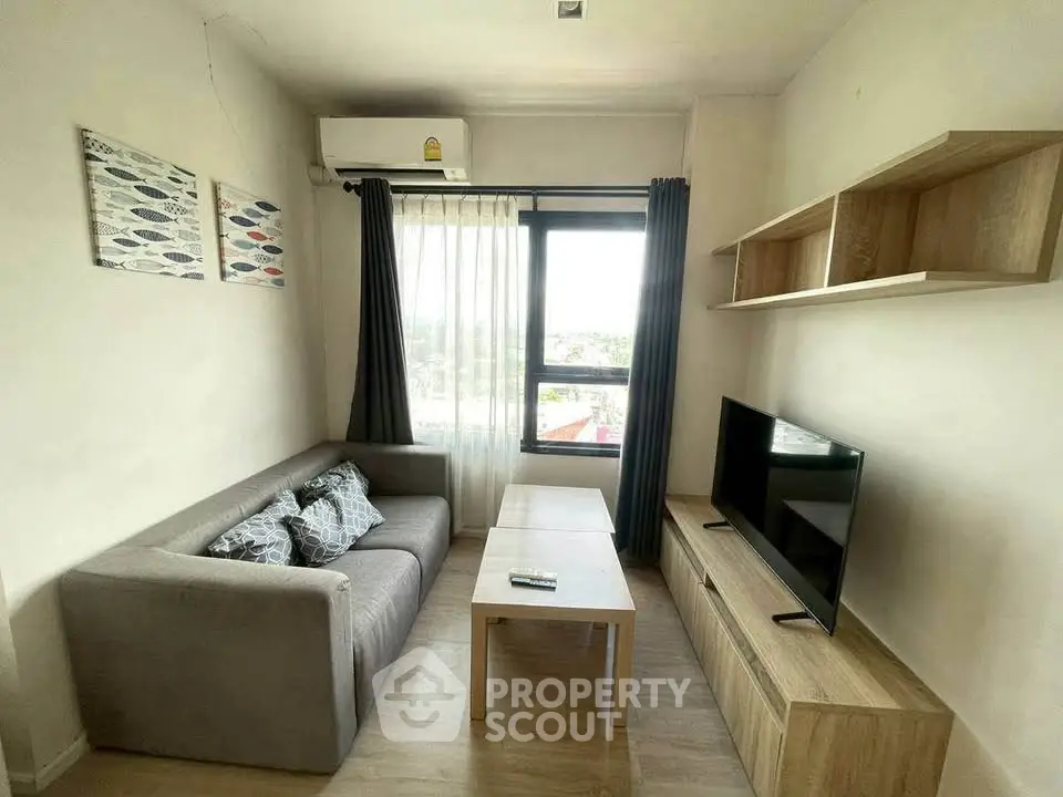 Modern living room with cozy sofa, wall-mounted shelves, and large window offering natural light.