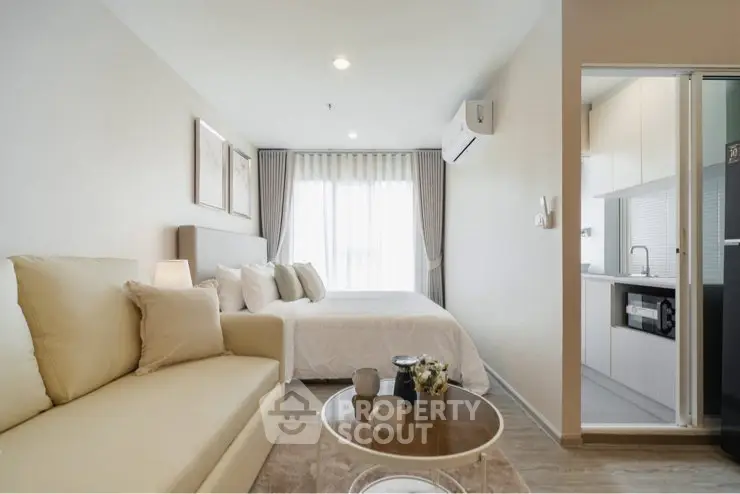 Modern studio apartment with cozy living area and compact kitchen