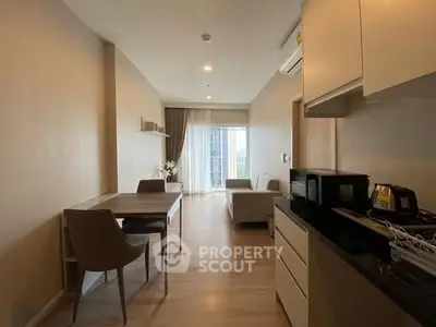 Modern apartment interior with open layout, featuring dining and living areas, sleek kitchen, and city view.
