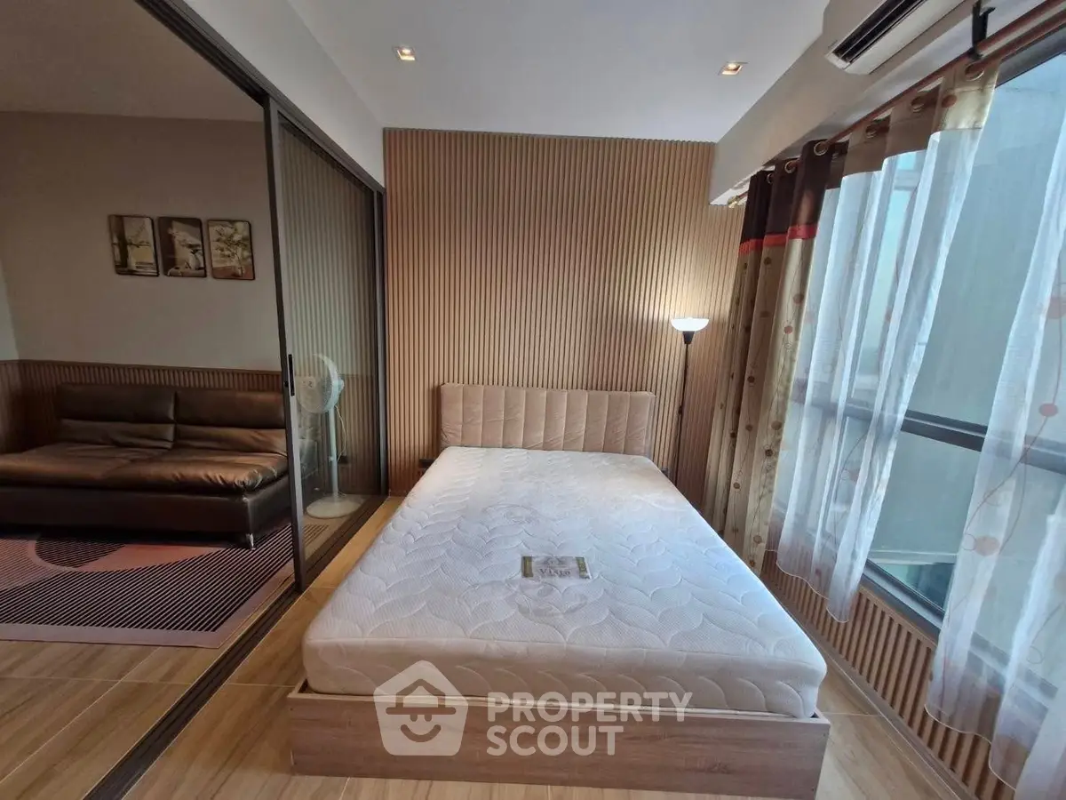 Modern bedroom with cozy decor and large window for natural light