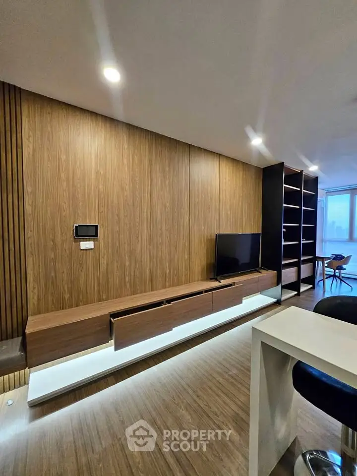 Modern living room with sleek wooden paneling and stylish TV unit