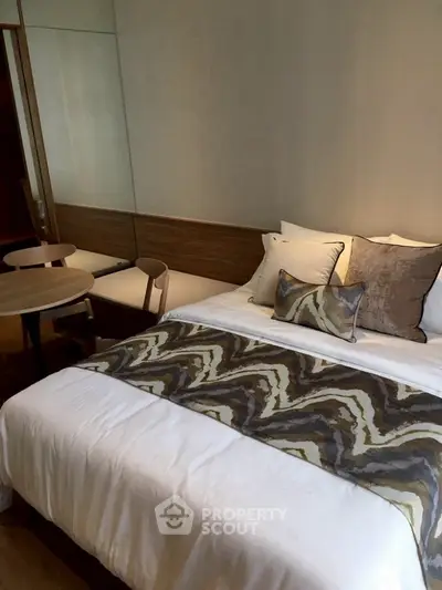 Cozy bedroom with stylish decor and modern furnishings in a contemporary apartment.