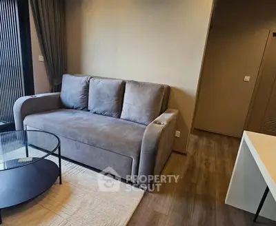 Modern living room with stylish sofa and glass coffee table in cozy apartment.