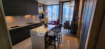 Modern kitchen with open layout and city view, featuring sleek cabinetry and dining area.