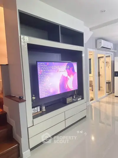 Modern living room with sleek entertainment center and glossy flooring