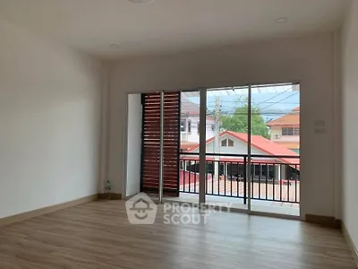 Spacious empty room with large windows and balcony view in modern home
