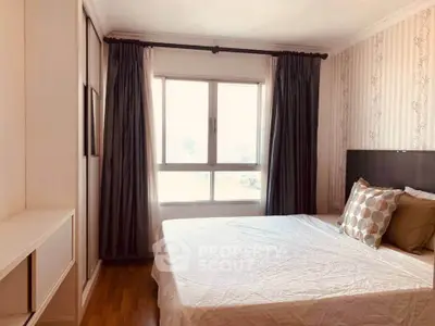 Bright and cozy bedroom with large window and stylish decor in modern apartment.