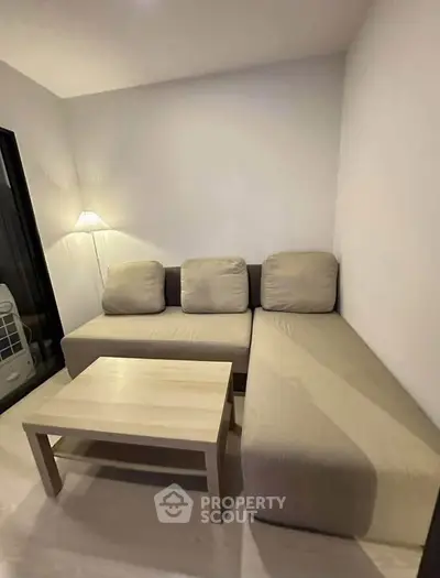 Cozy living room with modern beige sofa and wooden coffee table
