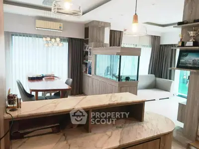 Luxurious living room with modern decor and large aquarium, perfect for relaxation.