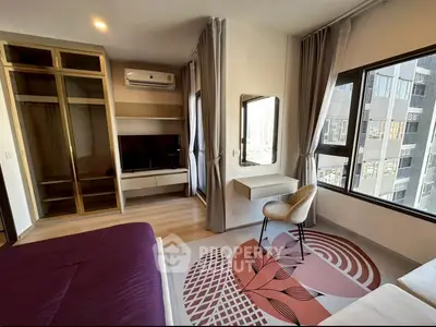 Modern bedroom with large windows, built-in wardrobe, and stylish decor in urban apartment.